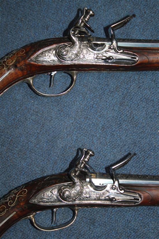 A pair of 18th century Bavarian flintlock holster pistols by Johann Jacob Kuchenreuter, overall length 21.5in.